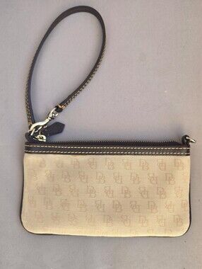 Dooney & Bourke Signature tan logo canvas wristlet with dark brown leather trim.